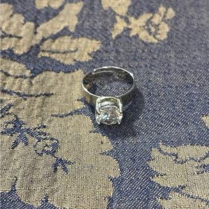 Lovely silver ring with white stone. New in box. Adjustable size.